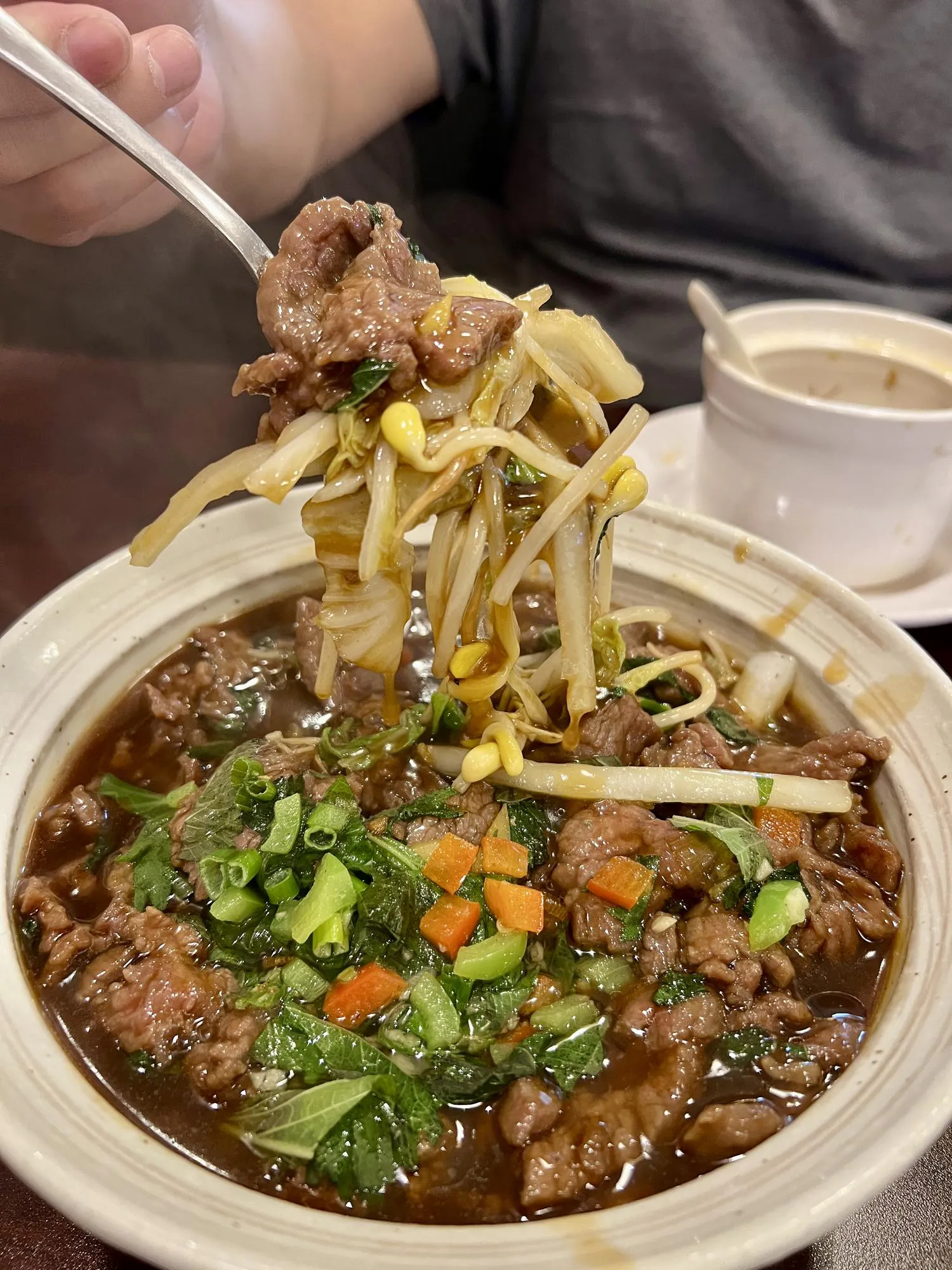 Beef hot pot with bean sprouts and herbs at Destination Café E Ramen, a Hong Kong-Style Cafe in Chicago